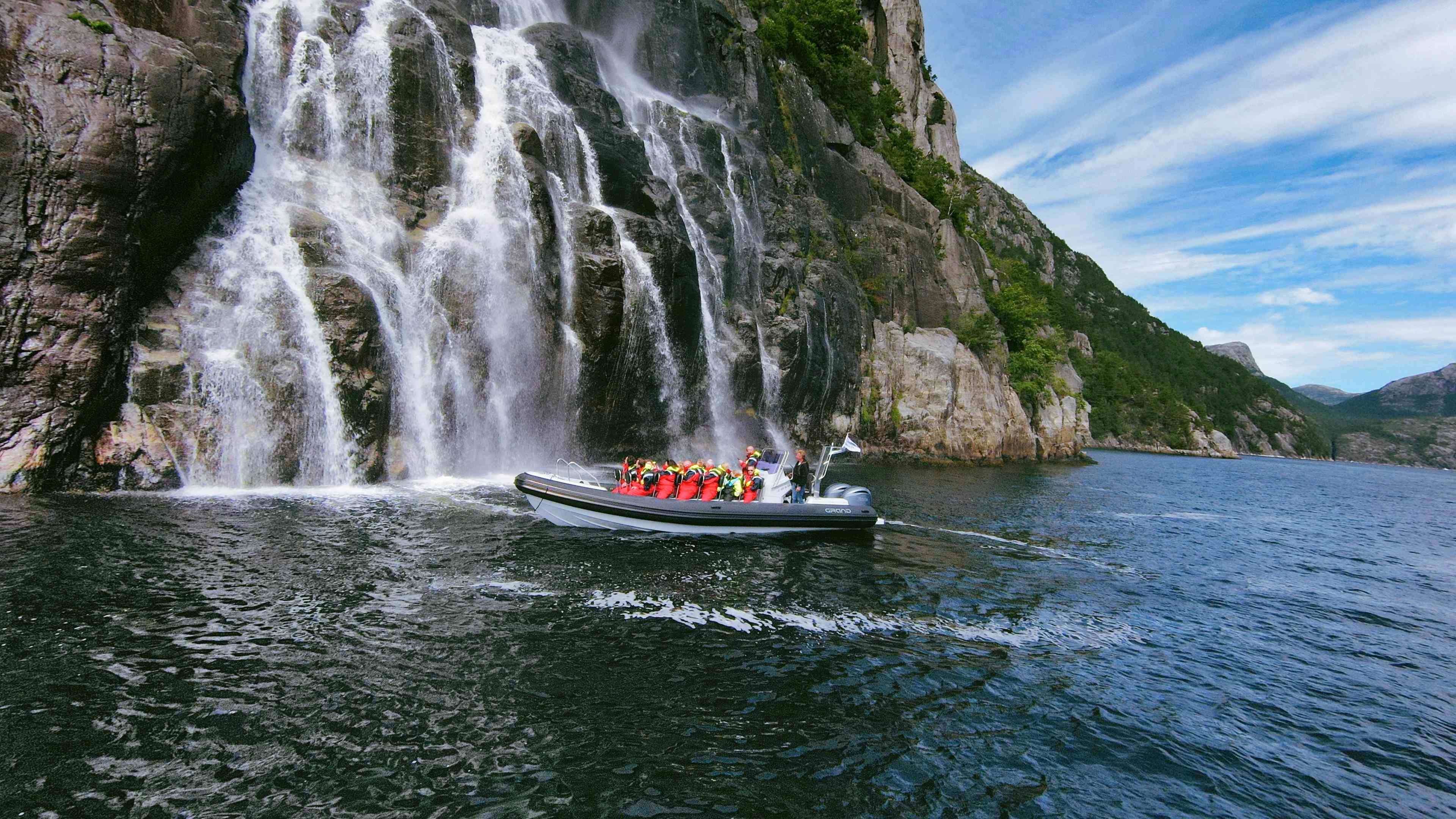 A RIB boat close to the Hengjanefossen waterfall