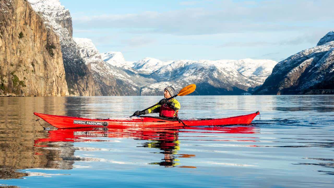 kayaking in winter in the Lysefjord, Norway, mountains with snow-capped tops