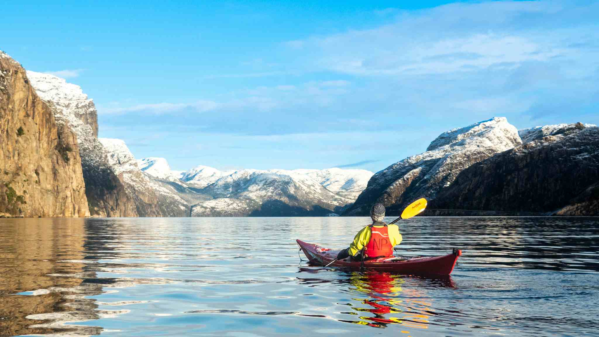 kayaking in winter in the Lysefjord, Norway, mountains with snow-capped tops